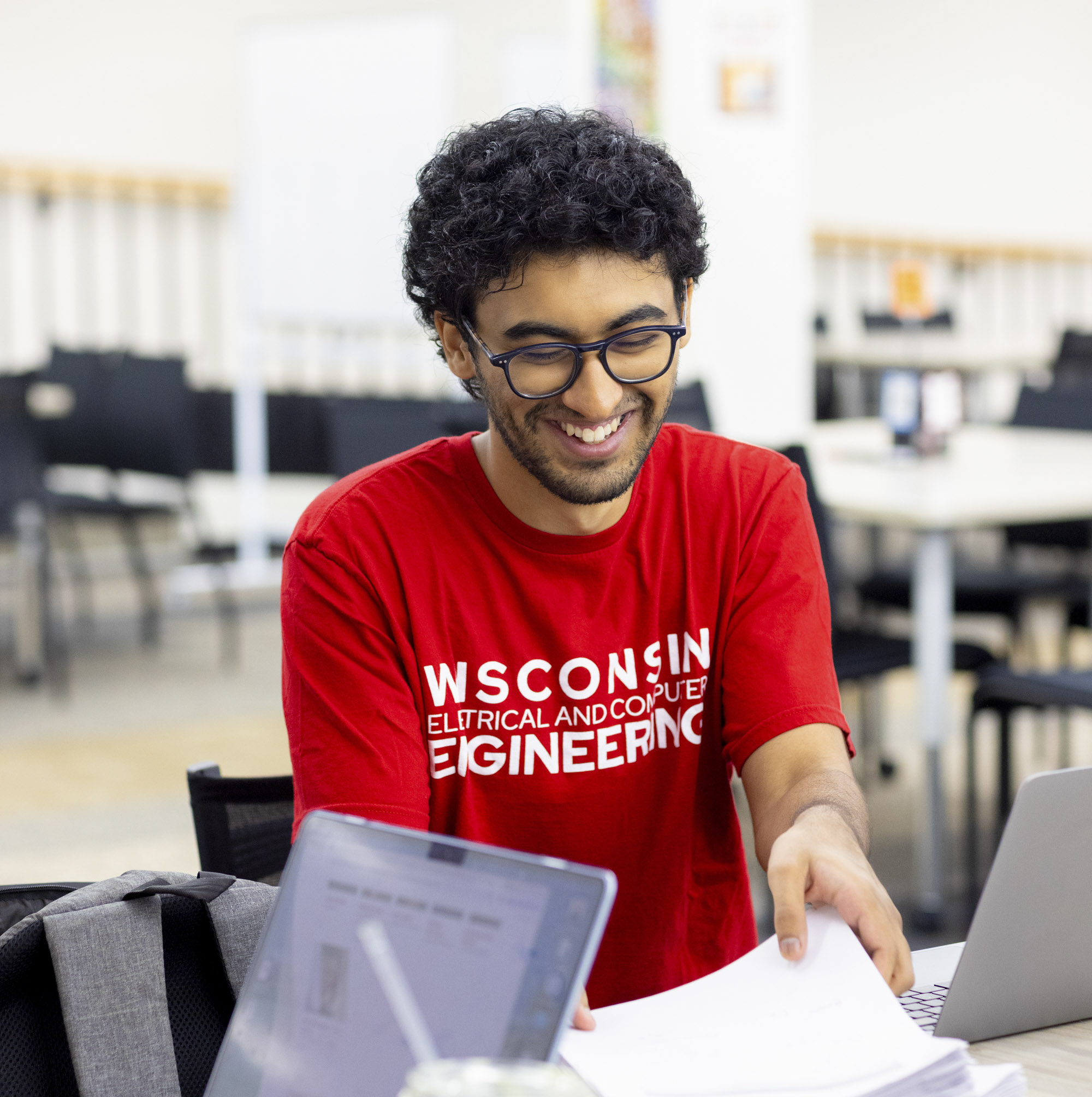 A student smiles while receiving drop-in tutoring services.