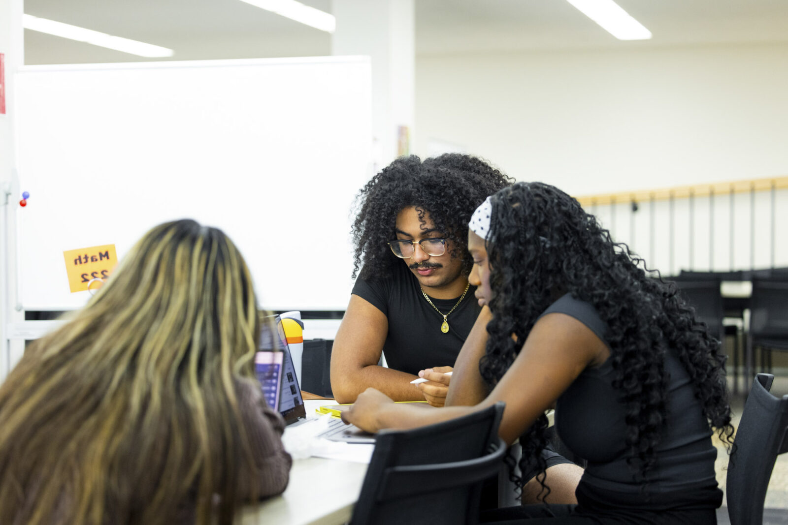 Three students study at drop-in tutoring in the MLC.