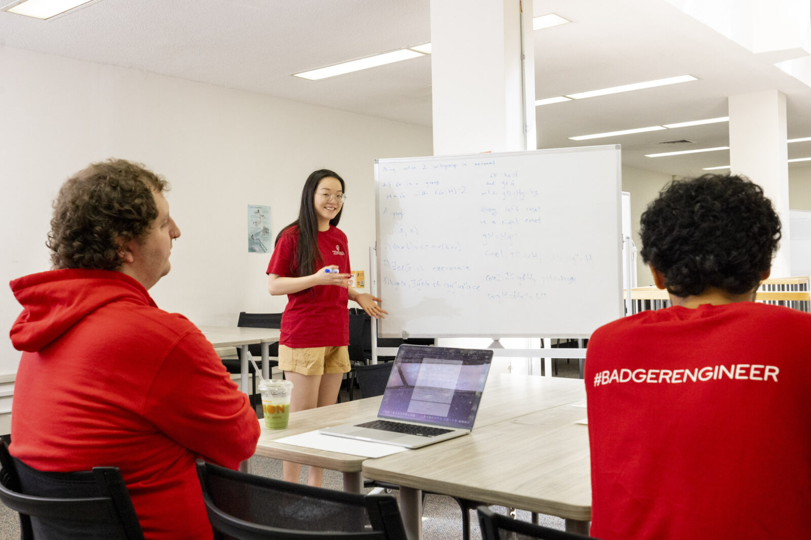 A student tutors two other students during her Course Assistant office hours in the Upper Level of the Math Learning Center.